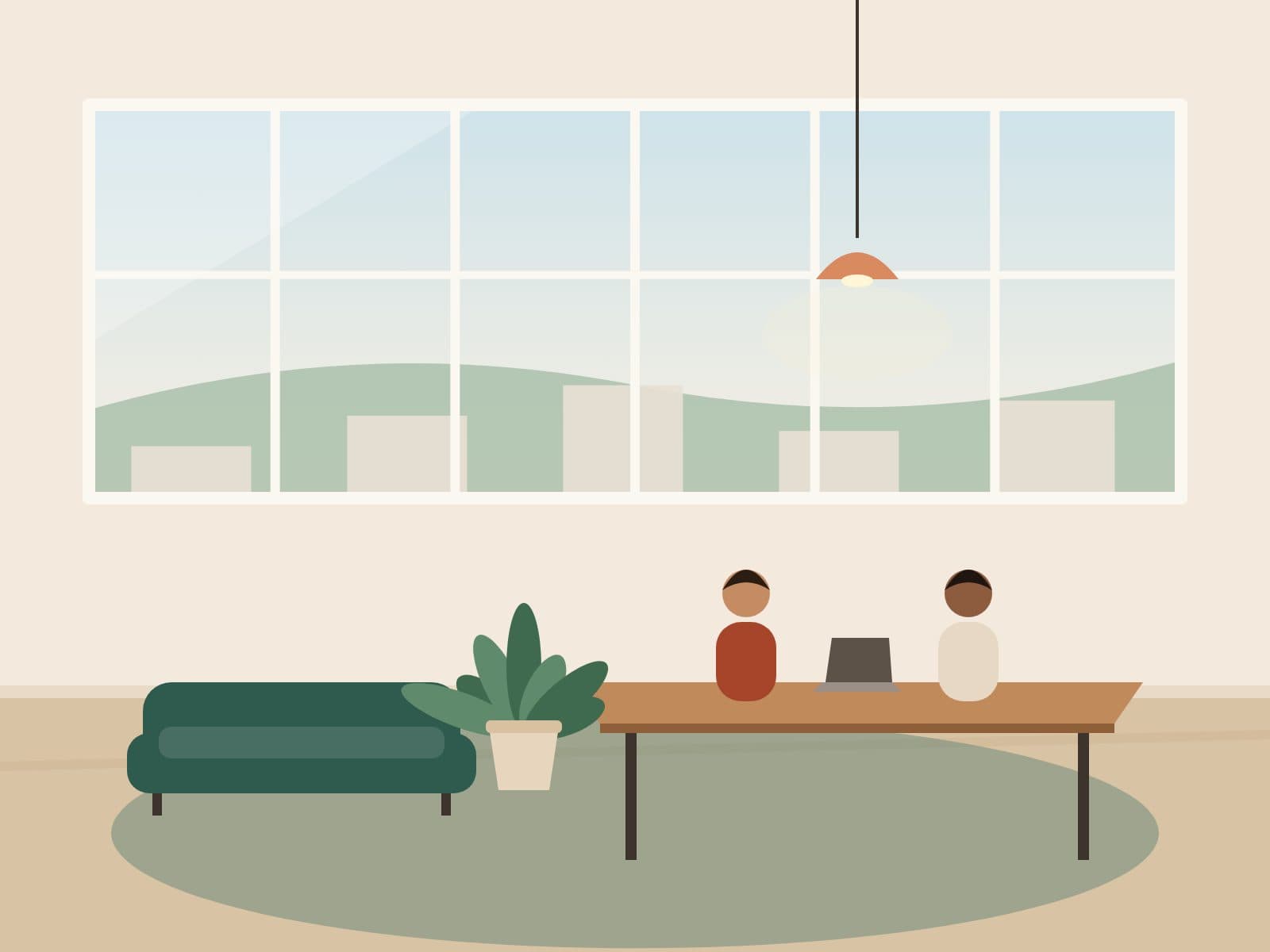 People working at a shared table in a bright coworking lounge