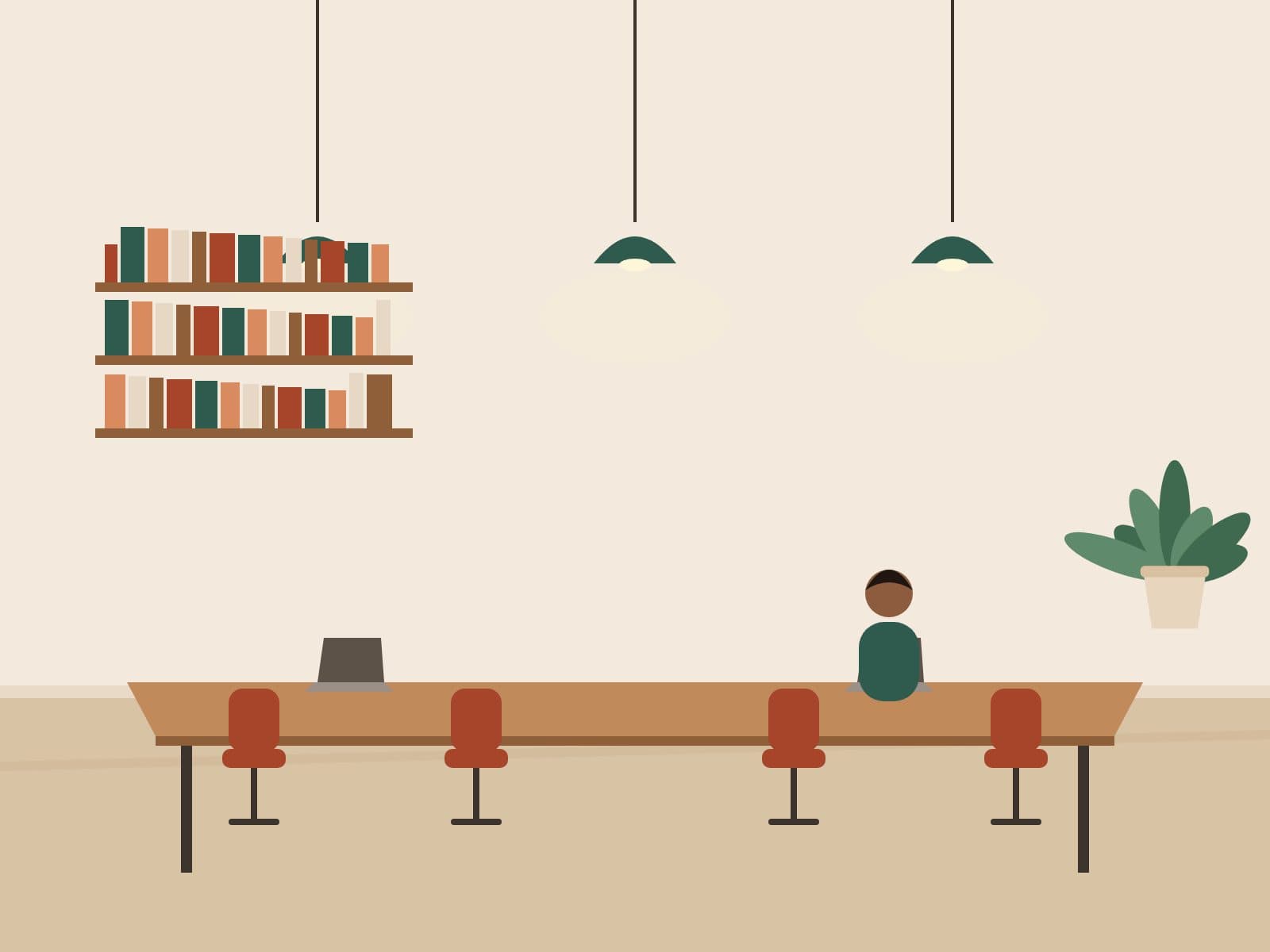 Shared work table with pendant lighting in the communal lounge
