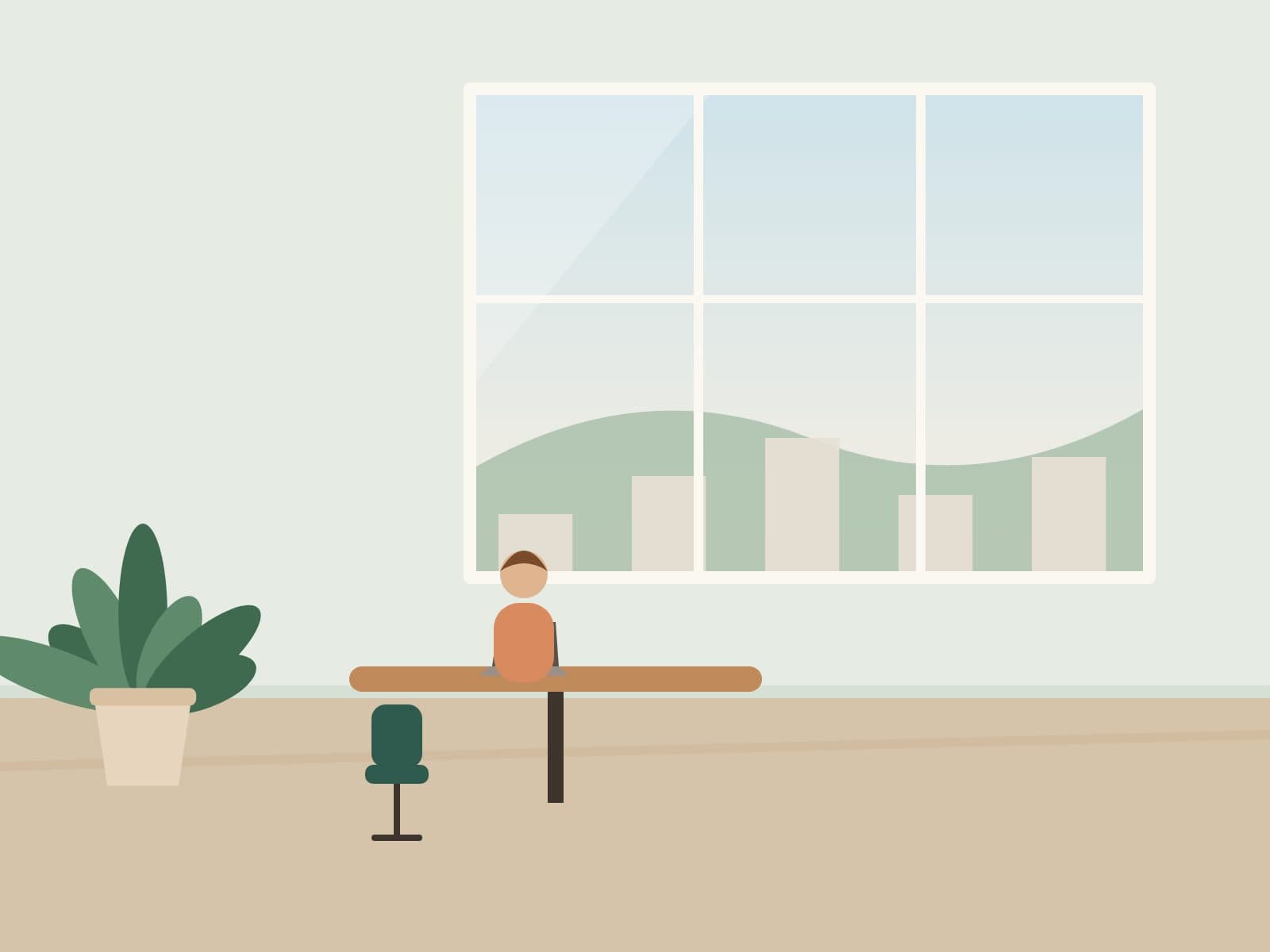 Person working on a laptop at a small table near a window